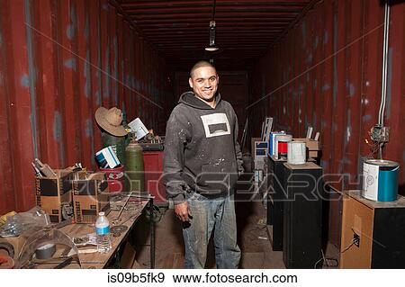 Portrait of builder in shipping container looking at camera smiling View Large Photo Image Stock Photo - Portrait of builder in shipping container looking at camera smiling. Fotosearch