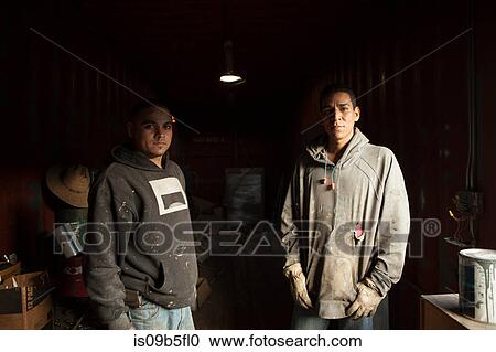 Portrait of builders in shipping container looking at camera View Large Photo Image Stock Image - Portrait of builders in shipping container looking at camera. Fotosearch