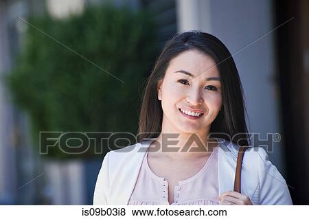 Portrait of businesswoman, outdoors, smiling View Large Photo Image Stock Photo - Portrait of businesswoman, outdoors, smiling. Fotosearch