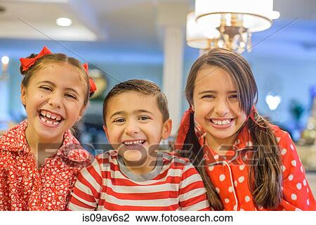 Portrait of children wearing pyjamas looking at camera smiling View Large Photo Image Stock Image - Portrait of children wearing pyjamas looking at camera smiling. Fotosearch