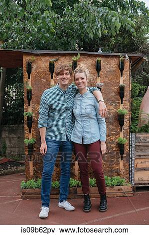 Portrait of couple in garden looking at camera smiling View Large Photo Image Stock Photo - Portrait of couple in garden looking at camera smiling. Fotosearch