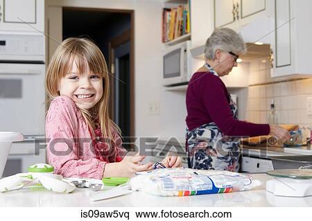 Portrait of cute girl cooking with grandmother View Large Photo Image Stock Photography - Portrait of cute girl cooking with grandmother. Fotosearch