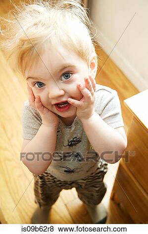 Portrait of cute male toddler with hands on cheeks View Large Photo Image Stock Photo - Portrait of cute male toddler with hands on cheeks. Fotosearch