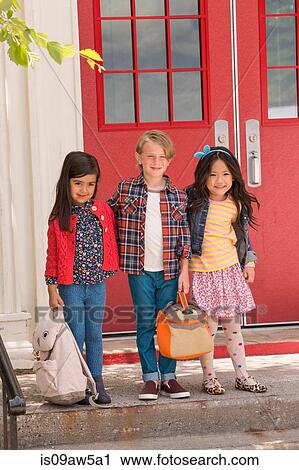 Portrait of elementary schoolboy and girls standing at elementary school doorway View Large Photo Image Stock Image - Portrait of elementary schoolboy and girls standing at elementary school doorway. Fotosearch