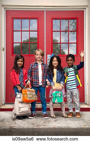 Portrait of elementary schoolgirls and boys waving from elementary school doorway View Large Photo Image Stock Photograph - Portrait of elementary schoolgirls and boys waving from elementary school doorway. Fotosearch