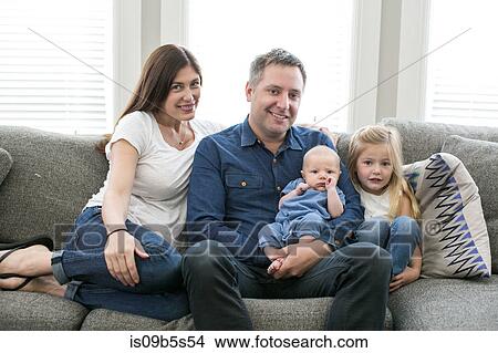 Portrait of family sitting on sofa View Large Photo Image Picture - Portrait of family sitting on sofa. Fotosearch