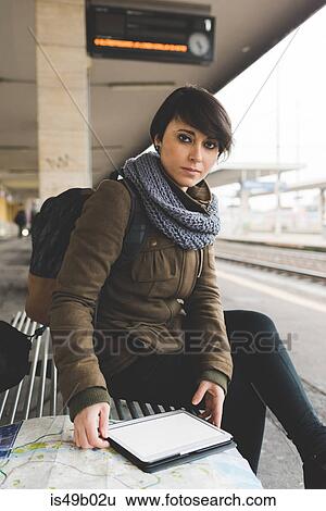 Portrait of female backpacker with map and digital tablet on railway platform View Large Photo Image Stock Photograph - Portrait of female backpacker with map and digital tablet on railway platform. Fotosearch
