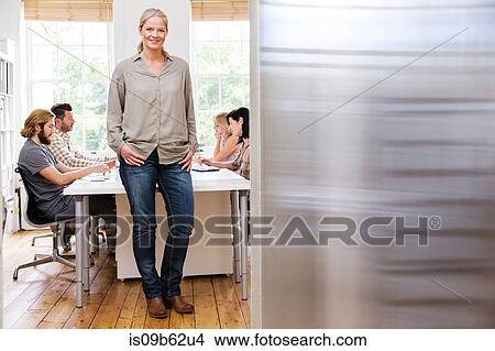 Picture - Portrait of female designer at meeting in creative studio. Fotosearch