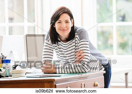 Portrait of female designer leaning forward on drawers in creative studio View Large Photo Image Stock Image - Portrait of female designer leaning forward on drawers in creative studio. Fotosearch