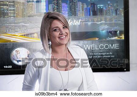 Portrait of female receptionist at hotel reception desk View Large Photo Image Picture - Portrait of female receptionist at hotel reception desk. Fotosearch