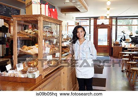 Stock Photography - Portrait of female worker in bakery. Fotosearch