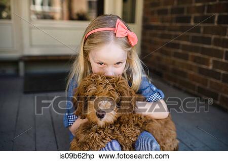 Portrait of girl kissing red haired puppy on front porch View Large Photo Image Stock Photography - Portrait of girl kissing red haired puppy on front porch. Fotosearch