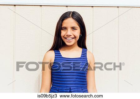 Stock Image - Portrait of girl looking at camera smiling. Fotosearch