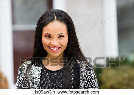Portrait of happy young woman outside house View Large Photo Image Stock Image - Portrait of happy young woman outside house. Fotosearch
