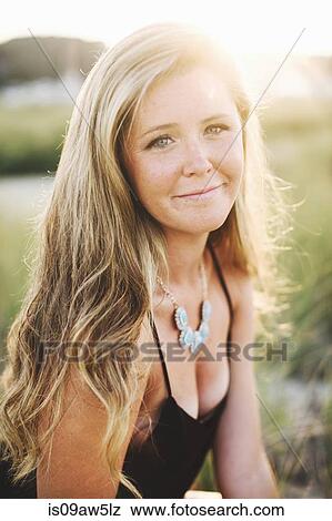 Portrait of long haired blonde woman looking at camera smiling View Large Photo Image Stock Photo - Portrait of long haired blonde woman looking at camera smiling. Fotosearch
