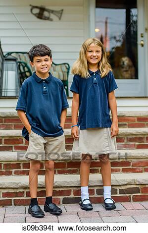 Portrait of male and female elementary school twins outside home porch View Large Photo Image Stock Photograph - Portrait of male and female elementary school twins outside home porch. Fotosearch