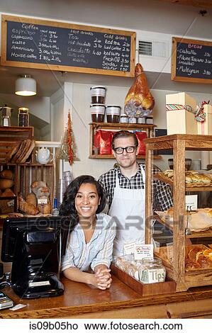 Picture - Portrait of male and female worker in bakery. Fotosearch