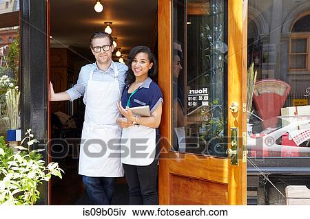 Portrait of male and female workers in bakery, standing in doorway View Large Photo Image Stock Photo - Portrait of male and female workers in bakery, standing in doorway. Fotosearch