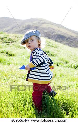 Portrait of male toddler looking back while toddling in grass View Large Photo Image Stock Photo - Portrait of male toddler looking back while toddling in grass. Fotosearch