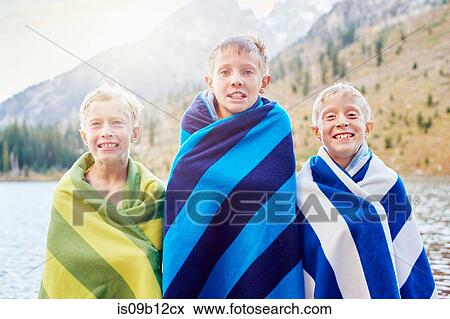 Portrait of male twins and brother wrapped in blankets, shivering, Grand Teton National Park, Wyoming, USA View Large Photo Image Stock Photo - Portrait of male twins and brother wrapped in blankets, shivering, Grand Teton National Park, Wyoming, USA. Fotosearch