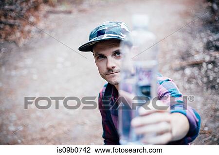 Portrait of man holding water bottle, Big Sur, California, USA View Large Photo Image Stock Image - Portrait of man holding water bottle, Big Sur, California, USA. Fotosearch