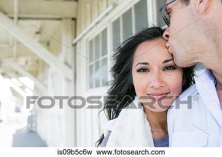 Portrait of man kissing girlfriend's forehead View Large Photo Image Stock Photo - Portrait of man kissing girlfriend's forehead. Fotosearch