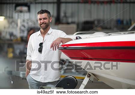 Portrait of man leaning against boat in repair workshop View Large Photo Image Stock Image - Portrait of man leaning against boat in repair workshop. Fotosearch