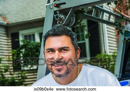 Portrait of man looking at camera smiling View Large Photo Image Stock Image - Portrait of man looking at camera smiling. Fotosearch