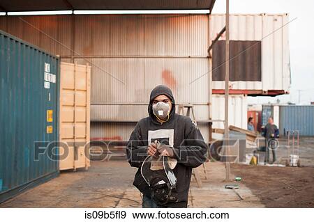 Stock Photo - Portrait of man on construction site wearing protective face mask. Fotosearch