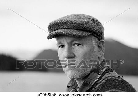 Portrait of man wearing flat cap looking away View Large Photo Image Stock Photograph - Portrait of man wearing flat cap looking away. Fotosearch