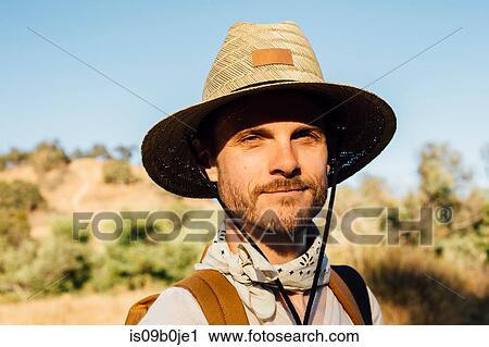 Portrait of man wearing sunhat looking at camera smiling, Malibu Canyon, California, USA View Large Photo Image Stock Image - Portrait of man wearing sunhat looking at camera smiling, Malibu Canyon, California, USA. Fotosearch