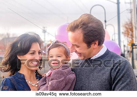 Portrait of mature couple with young daughter, outdoors View Large Photo Image Stock Photography - Portrait of mature couple with young daughter, outdoors. Fotosearch