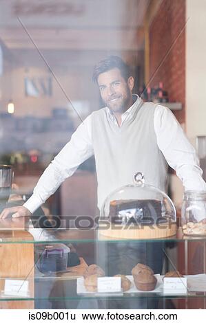 Portrait of mature man behind counter in cafe View Large Photo Image Stock Photograph - Portrait of mature man behind counter in cafe. Fotosearch