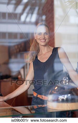 Portrait of mature woman behind counter in cafe View Large Photo Image Stock Photography - Portrait of mature woman behind counter in cafe. Fotosearch
