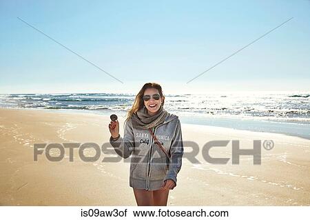 Portrait of mature woman holding seashell on beach, Conil de la Frontera, Spain View Large Photo Image Stock Image - Portrait of mature woman holding seashell on beach, Conil de la Frontera, Spain. Fotosearch