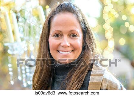 Portrait of mature woman in front of decorative lights View Large Photo Image Stock Image - Portrait of mature woman in front of decorative lights. Fotosearch