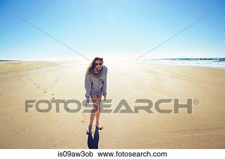Stock Image - Portrait of mature woman laughing on beach, Conil de la frontera, Spain. Fotosearch