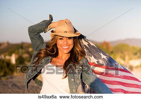 Portrait of mature woman, outdoors, holding American flag, smiling View Large Photo Image Stock Image - Portrait of mature woman, outdoors, holding American flag, smiling. Fotosearch