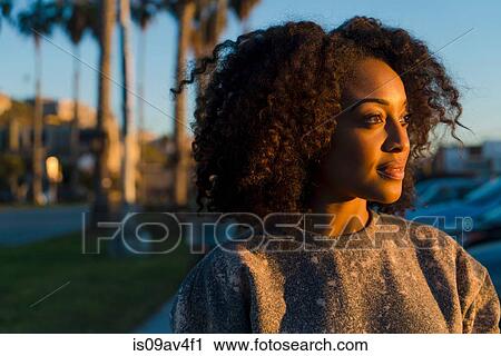 Portrait of mid adult woman, looking towards sun View Large Photo Image Stock Image - Portrait of mid adult woman, looking towards sun. Fotosearch
