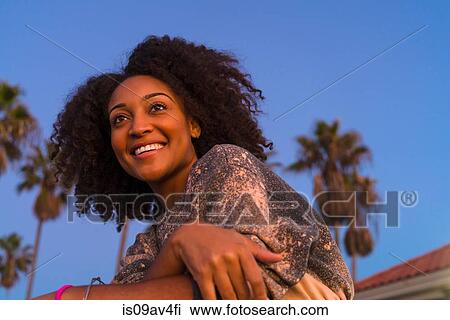 Portrait of mid adult woman, outdoors, smiling View Large Photo Image Stock Image - Portrait of mid adult woman, outdoors, smiling. Fotosearch
