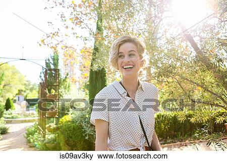 Portrait of mid adult woman outdoors, smiling View Large Photo Image Stock Photo - Portrait of mid adult woman outdoors, smiling. Fotosearch