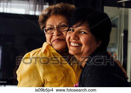 Portrait of mother and adult daughter hugging View Large Photo Image Picture - Portrait of mother and adult daughter hugging. Fotosearch