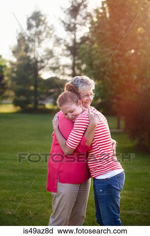Portrait of mother and adult daughter, hugging View Large Photo Image Stock Image - Portrait of mother and adult daughter, hugging. Fotosearch