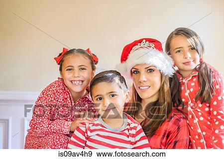 Portrait of mother and children, mother wearing festive hat View Large Photo Image Stock Photo - Portrait of mother and children, mother wearing festive hat. Fotosearch