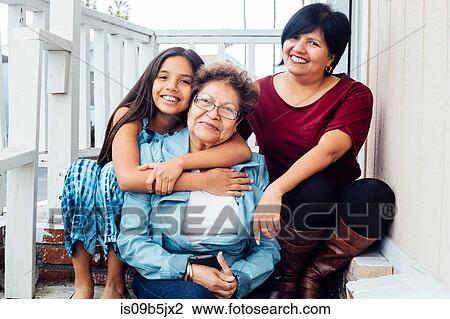 Portrait of multi generational family looking at camera smiling View Large Photo Image Stock Image - Portrait of multi generational family looking at camera smiling. Fotosearch