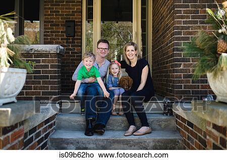 Portrait of parents sitting on porch steps with daughter and son View Large Photo Image Picture - Portrait of parents sitting on porch steps with daughter and son. Fotosearch