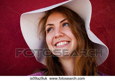 Portrait of pierced woman wearing sunhat looking away smiling View Large Photo Image Stock Image - Portrait of pierced woman wearing sunhat looking away smiling. Fotosearch