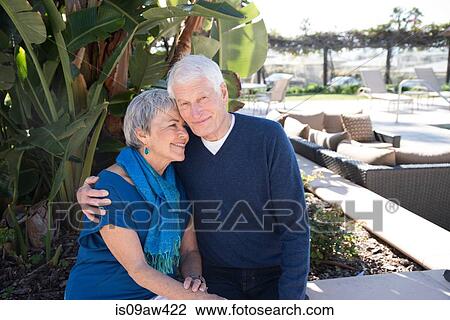 Stock Image - Portrait of senior couple outdoors, smiling. Fotosearch