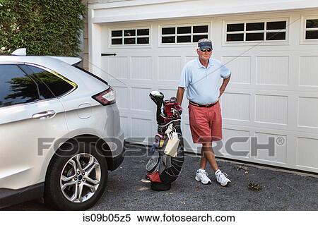 Portrait of senior male golfer standing next to garage door with golf bag View Large Photo Image Stock Photography - Portrait of senior male golfer standing next to garage door with golf bag. Fotosearch