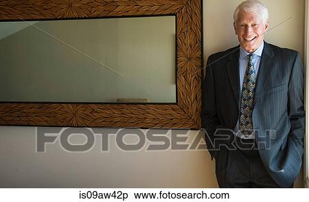 Portrait of senior man indoors, wearing suit, smiling View Large Photo Image Stock Photography - Portrait of senior man indoors, wearing suit, smiling. Fotosearch